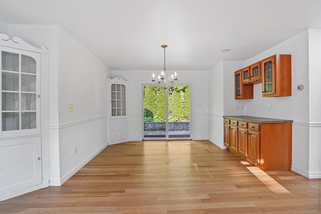 40A Mount Pleasant Rd, Newtown, CT 06470 - unfurnished dining area with a chandelier, light wood-type flooring, and baseboards