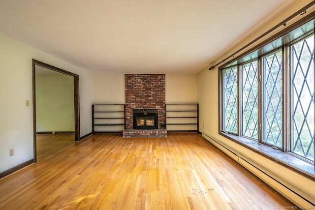 58 Wildwood Ln, Durham, CT 06422 - unfurnished living room featuring a baseboard radiator, plenty of natural light, and light wood finished floors