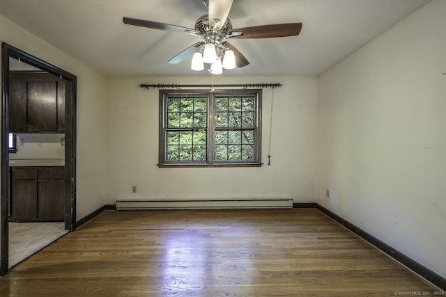 58 Wildwood Ln, Durham, CT 06422 - unfurnished room featuring wood finished floors, a ceiling fan, baseboards, and baseboard heating