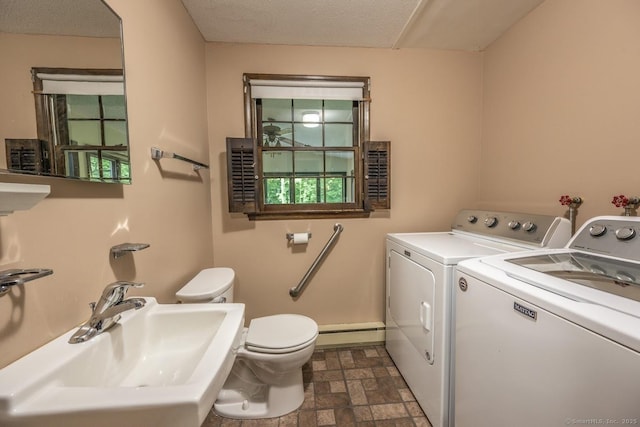 58 Wildwood Ln, Durham, CT 06422 - laundry area featuring washing machine and dryer, a baseboard heating unit, and stone finish flooring