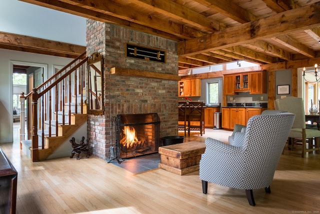 1900 Home Rd, Great Barrington, MA 01230 - living room with light wood-style floors, wood ceiling with exposed beams, stairway, and a brick fireplace