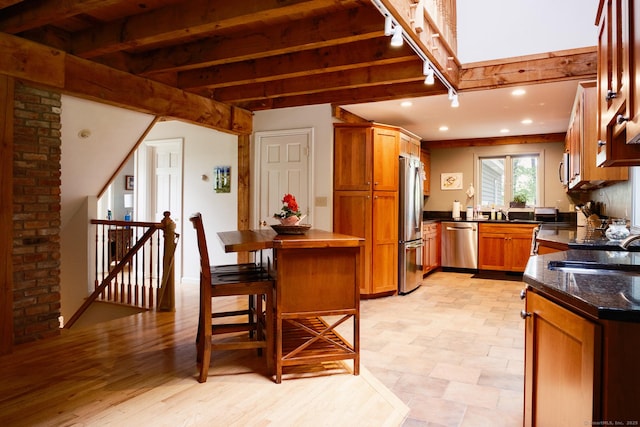 1900 Home Rd, Great Barrington, MA 01230 - kitchen with appliances with stainless steel finishes, beamed ceiling, brown cabinetry, a sink, and recessed lighting