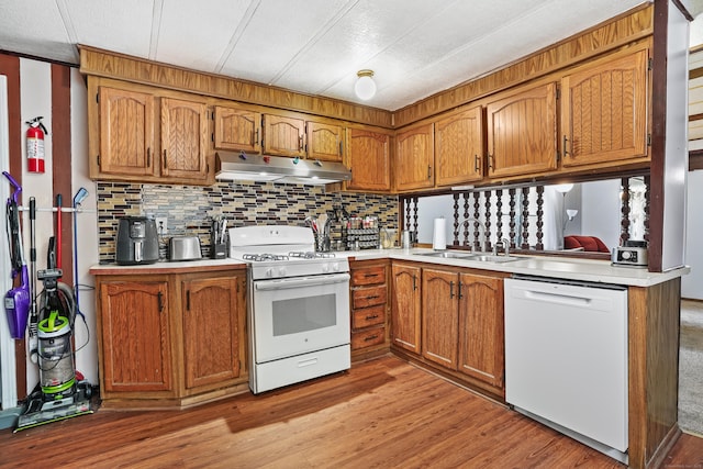 70 Woodland Park, Shelton, CT 06484 - kitchen featuring white appliances, under cabinet range hood, a sink, brown cabinetry, and light countertops