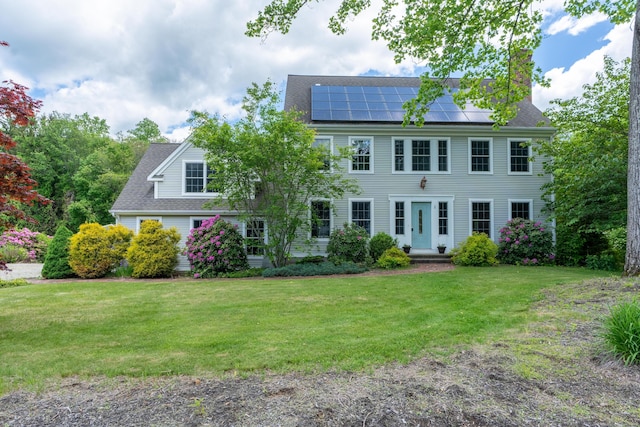 2 Acorn Dr, East Haddam, CT 06423 - colonial house featuring a front yard, roof mounted solar panels, a chimney, and a shingled roof