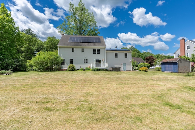 2 Acorn Dr, East Haddam, CT 06423 - rear view of house with solar panels, a yard, and a deck