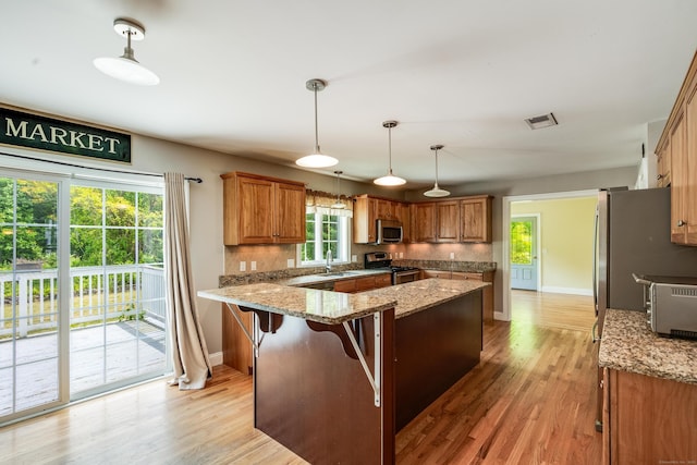 2 Acorn Dr, East Haddam, CT 06423 - kitchen with stainless steel appliances, a sink, light wood finished floors, and brown cabinetry