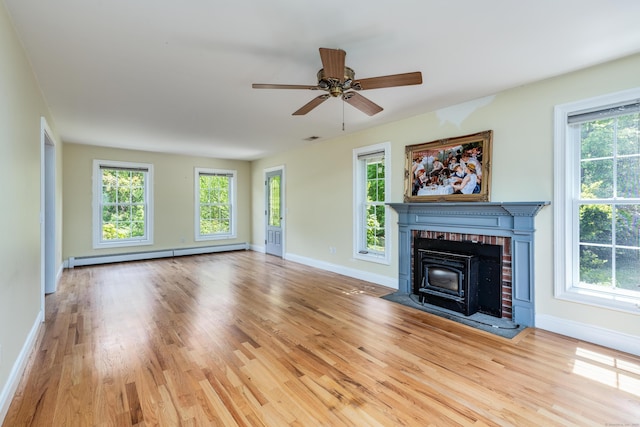 2 Acorn Dr, East Haddam, CT 06423 - unfurnished living room featuring baseboard heating, wood finished floors, baseboards, and a ceiling fan