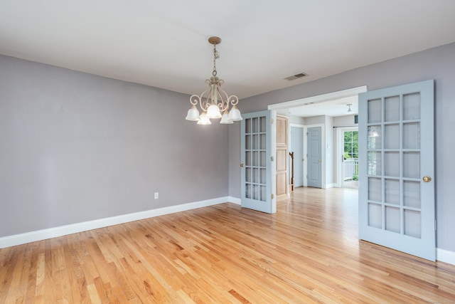 2 Acorn Dr, East Haddam, CT 06423 - spare room featuring french doors, a chandelier, baseboards, and light wood finished floors