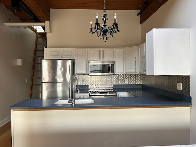68 Thermos Ave Unit 410E, Norwich, CT 06360 - kitchen featuring stainless steel appliances, dark countertops, decorative backsplash, and white cabinetry
