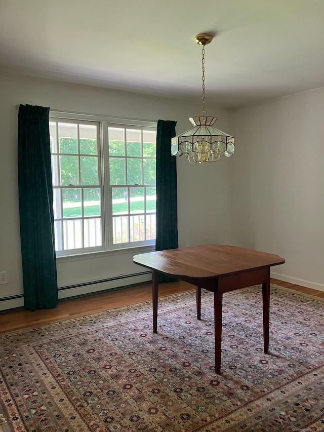 116 Taylor Rd, New Milford, CT 06776 - dining area featuring wood finished floors, a chandelier, and a baseboard radiator