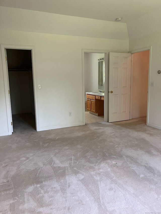 116 Taylor Rd, New Milford, CT 06776 - unfurnished bedroom featuring a spacious closet, light carpet, ensuite bathroom, and a closet