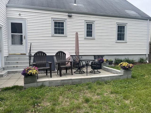 24 Westview St, Hamden, CT 06514 - back of property with entry steps, roof with shingles, a yard, and a patio