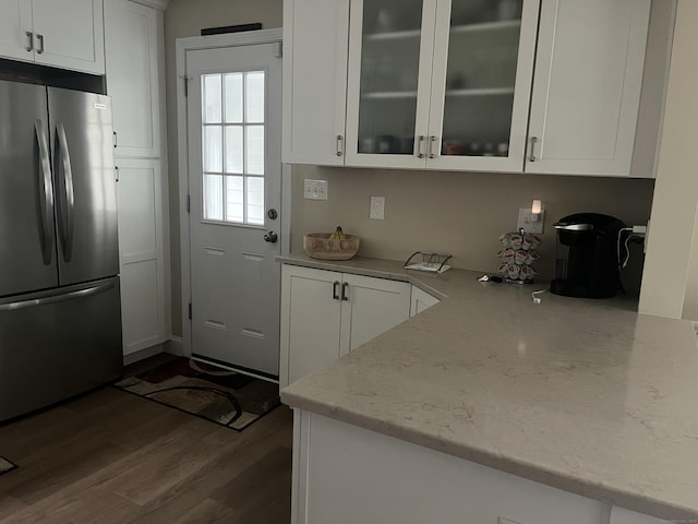 24 Westview St, Hamden, CT 06514 - kitchen featuring freestanding refrigerator, white cabinetry, light stone counters, dark wood finished floors, and glass insert cabinets