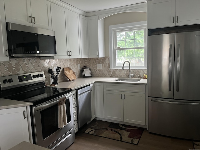 24 Westview St, Hamden, CT 06514 - kitchen featuring appliances with stainless steel finishes, a sink, light countertops, dark wood finished floors, and backsplash