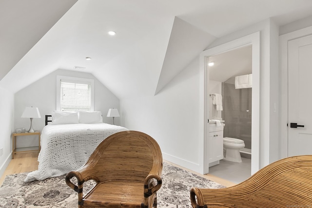 1 Howard Ave Unit C2, Norwalk, CT 06855 - bedroom with vaulted ceiling, baseboards, connected bathroom, and light wood-style floors