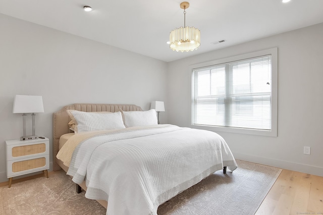 1 Howard Ave Unit C2, Norwalk, CT 06855 - bedroom with wood finished floors, baseboards, and a chandelier