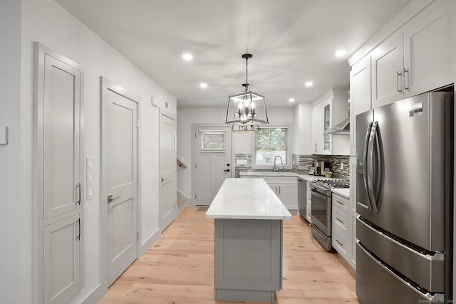 1 Howard Ave Unit C2, Norwalk, CT 06855 - kitchen featuring stainless steel appliances, a kitchen island, light wood finished floors, recessed lighting, and decorative backsplash