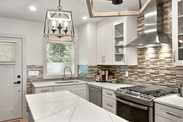 1 Howard Ave Unit C2, Norwalk, CT 06855 - kitchen featuring wall chimney range hood, appliances with stainless steel finishes, a sink, backsplash, and white cabinets