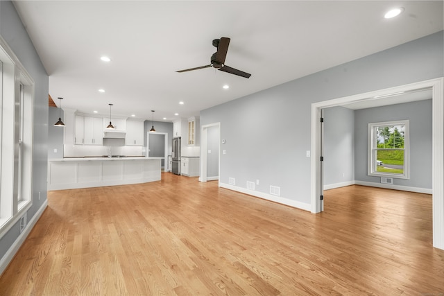 14 Fiddlehead Pl, Suffield, CT 06078 - unfurnished living room featuring a ceiling fan, a sink, light wood-style floors, recessed lighting, and baseboards