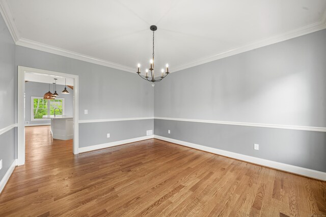 14 Fiddlehead Pl, Suffield, CT 06078 - spare room with a chandelier, crown molding, wood finished floors, and baseboards