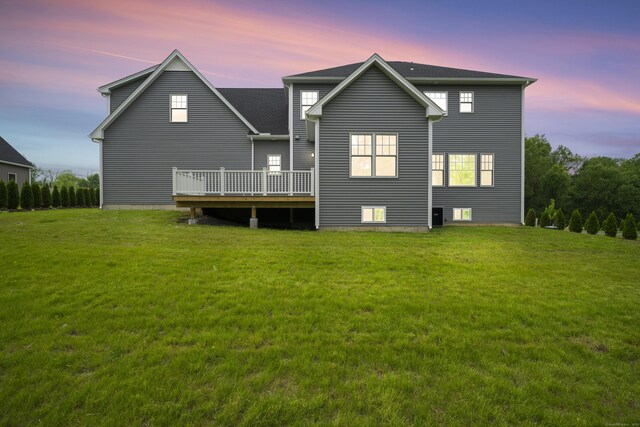 14 Fiddlehead Pl, Suffield, CT 06078 - back of property at dusk with a lawn and a deck