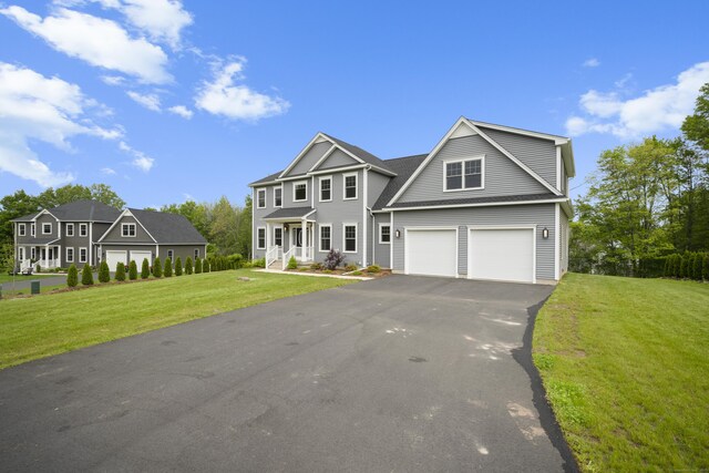 14 Fiddlehead Pl, Suffield, CT 06078 - view of front of property featuring asphalt driveway, an attached garage, and a front yard
