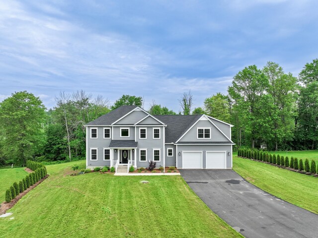 14 Fiddlehead Pl, Suffield, CT 06078 - view of front of property featuring driveway, a front yard, and view of scattered trees