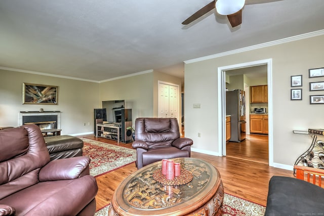 20 Canterbury Rd Unit 20, Hamden, CT 06514 - living room featuring ceiling fan, crown molding, light wood-type flooring, and a glass covered fireplace