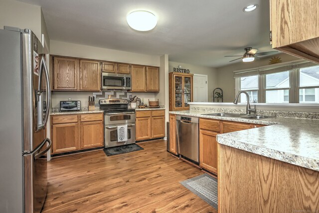 20 Canterbury Rd Unit 20, Hamden, CT 06514 - kitchen with appliances with stainless steel finishes, ceiling fan, light countertops, wood finished floors, and brown cabinets