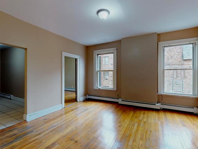 24 Townley St, Hartford, CT 06105 - empty room with a baseboard radiator, plenty of natural light, light wood-style floors, and baseboard heating