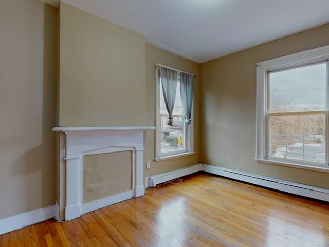 24 Townley St, Hartford, CT 06105 - unfurnished living room with wood finished floors, plenty of natural light, baseboards, and a fireplace