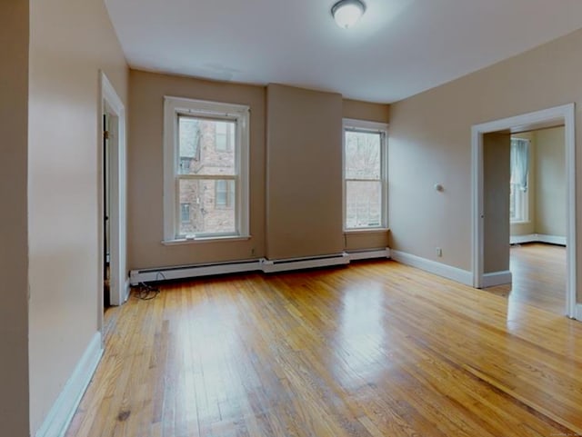 24 Townley St, Hartford, CT 06105 - unfurnished room featuring baseboard heating, light wood-style flooring, and baseboards