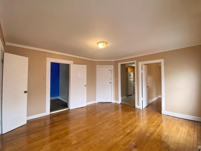 24 Townley St, Hartford, CT 06105 - unfurnished bedroom with freestanding refrigerator, hardwood / wood-style flooring, baseboards, and crown molding