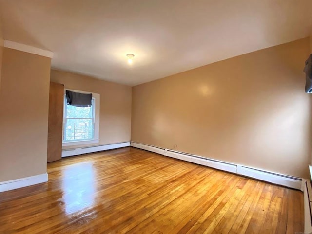 24 Townley St, Hartford, CT 06105 - empty room with wood finished floors, a baseboard heating unit, and baseboards