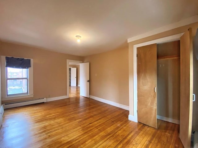 24 Townley St, Hartford, CT 06105 - unfurnished bedroom with a baseboard radiator, wood-type flooring, and baseboards