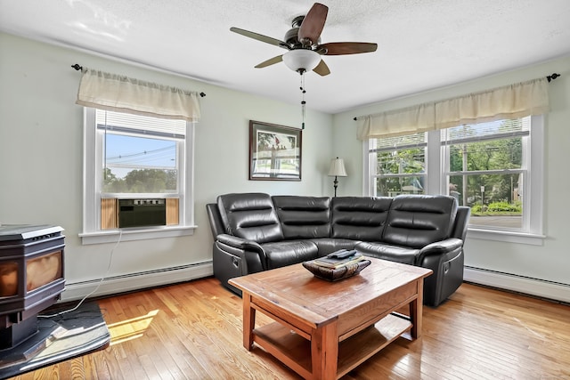 355 Farmington Ave, Bristol, CT 06010 - living room with a baseboard heating unit, cooling unit, hardwood / wood-style flooring, and a textured ceiling