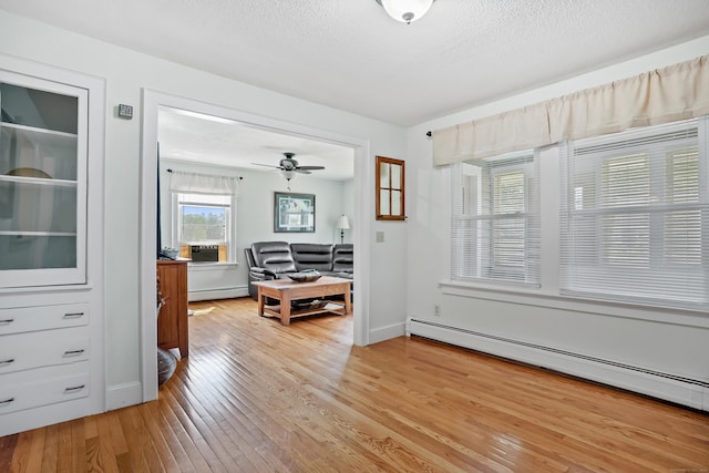 355 Farmington Ave, Bristol, CT 06010 - interior space featuring a baseboard heating unit, light wood-type flooring, a textured ceiling, and a ceiling fan