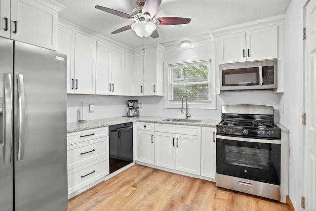 355 Farmington Ave, Bristol, CT 06010 - kitchen featuring appliances with stainless steel finishes, white cabinets, a ceiling fan, and light wood finished floors