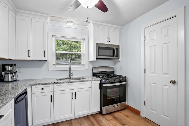 355 Farmington Ave, Bristol, CT 06010 - kitchen featuring stainless steel appliances, a ceiling fan, light wood-style flooring, and white cabinets