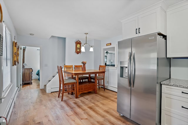355 Farmington Ave, Bristol, CT 06010 - kitchen featuring stainless steel fridge with ice dispenser, light wood-style floors, a baseboard heating unit, white cabinets, and light stone countertops