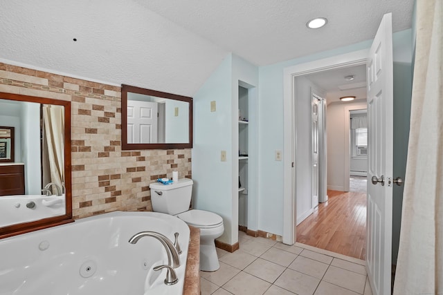 355 Farmington Ave, Bristol, CT 06010 - full bathroom with a textured ceiling, tile patterned flooring, a whirlpool tub, baseboard heating, and built in shelves