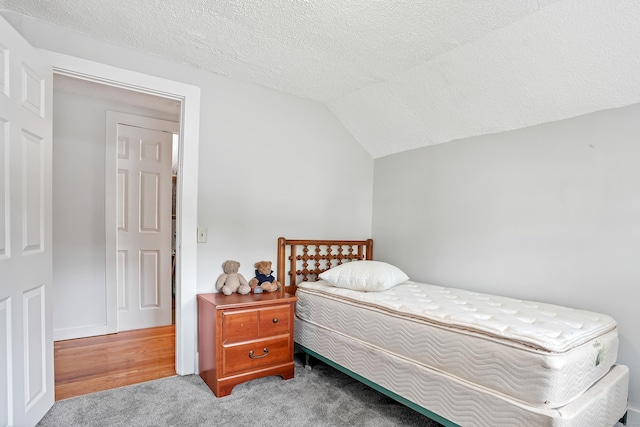 355 Farmington Ave, Bristol, CT 06010 - carpeted bedroom featuring lofted ceiling and a textured ceiling