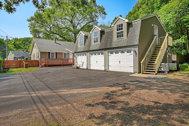 355 Farmington Ave, Bristol, CT 06010 - colonial inspired home featuring driveway, stairs, a gambrel roof, a shingled roof, and a deck