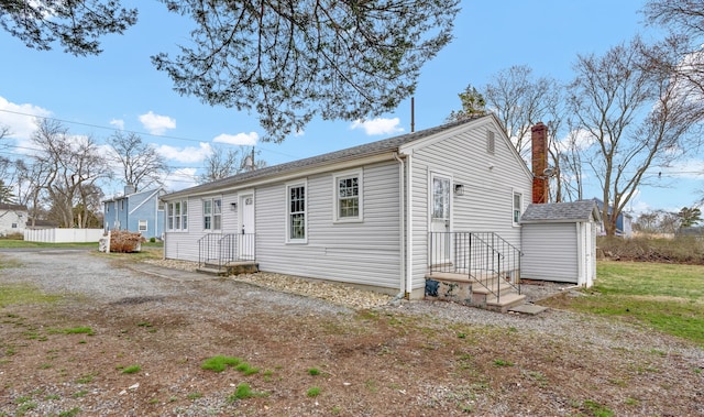 14 Denmore Ln, Old Saybrook, CT 06475 - back of house featuring a chimney and roof with shingles