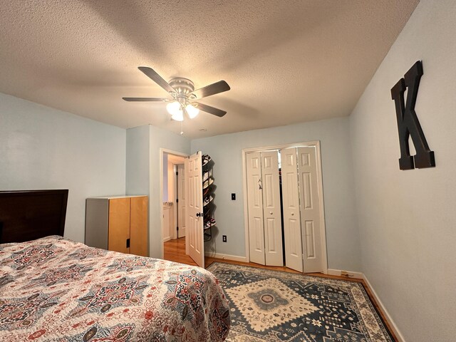 529 Woodward Ave Apt C, New Haven, CT 06512 - bedroom with baseboards, wood finished floors, a textured ceiling, a ceiling fan, and a closet