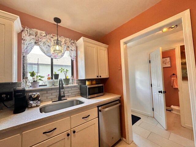 529 Woodward Ave Apt C, New Haven, CT 06512 - kitchen featuring appliances with stainless steel finishes, a sink, tasteful backsplash, light tile patterned flooring, and hanging light fixtures
