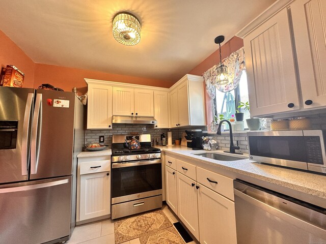 529 Woodward Ave Apt C, New Haven, CT 06512 - kitchen featuring stainless steel appliances, under cabinet range hood, a sink, light countertops, and backsplash