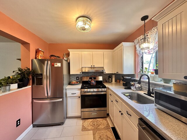 529 Woodward Ave Apt C, New Haven, CT 06512 - kitchen with appliances with stainless steel finishes, a sink, under cabinet range hood, a chandelier, and light countertops