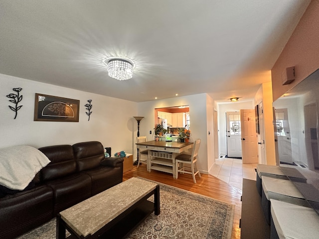 529 Woodward Ave Apt C, New Haven, CT 06512 - living room featuring light wood-type flooring, a chandelier, and baseboards