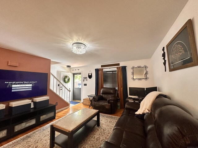 529 Woodward Ave Apt C, New Haven, CT 06512 - living area with wood finished floors, stairway, and a chandelier